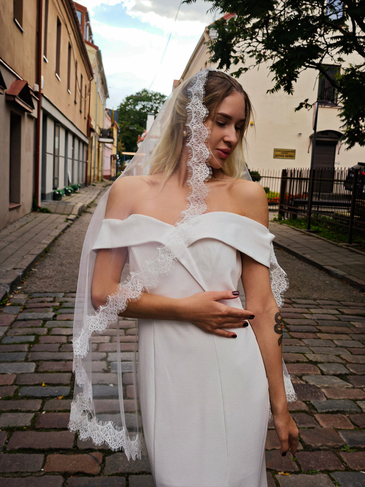Detail of the hand-sewn narrow Chantilly lace edge on an ivory mantilla wedding veil