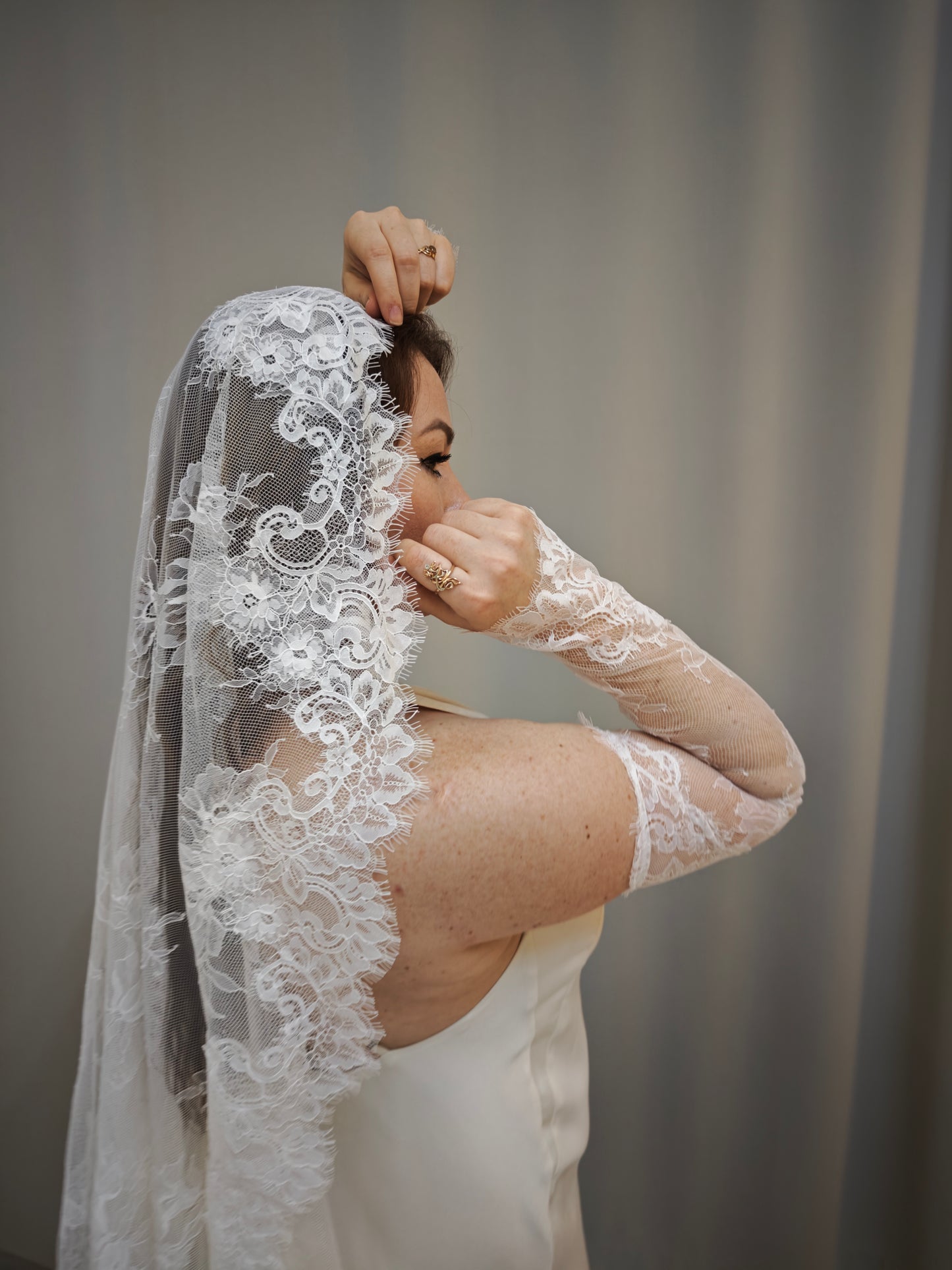 Fingerless ivory lace bridal gloves, Chantilly lace, floral pattern close-up