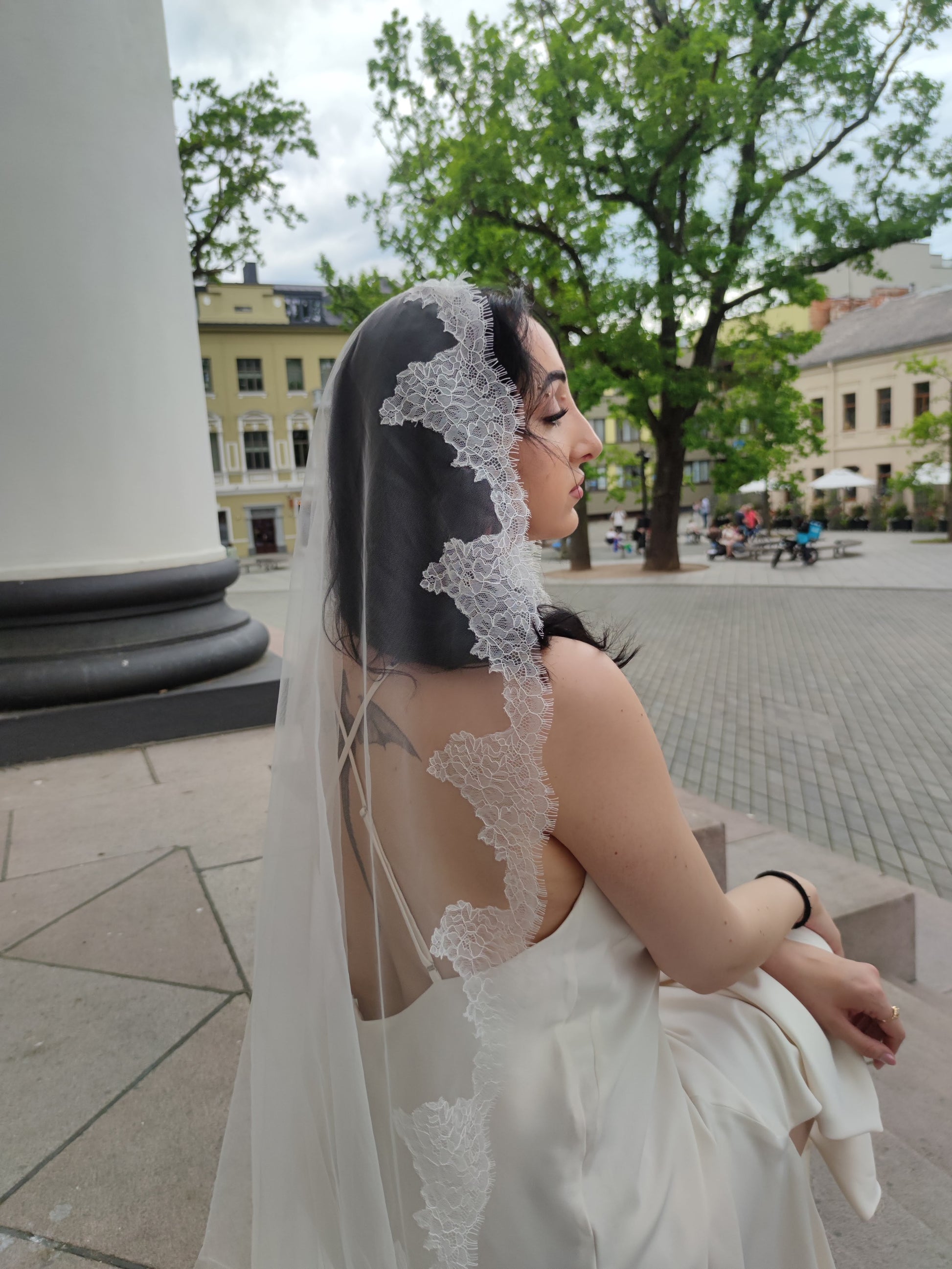 The Laima light ivory mantilla veil with scalloped floral Chantilly lace edge over dotted tulle, full length