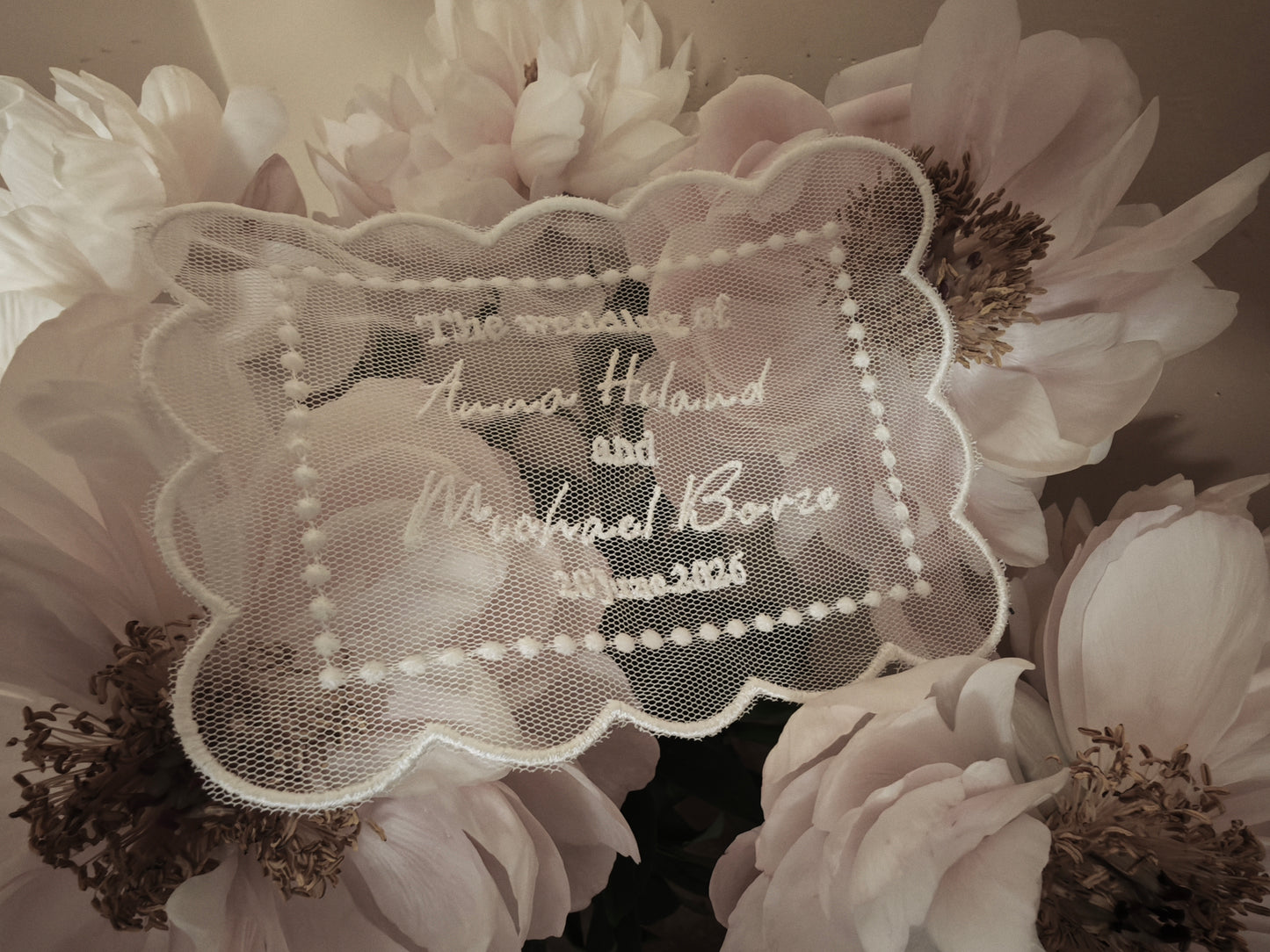 Personalized embroidered tulle wedding invitation, ivory, close-up of embroidery detail