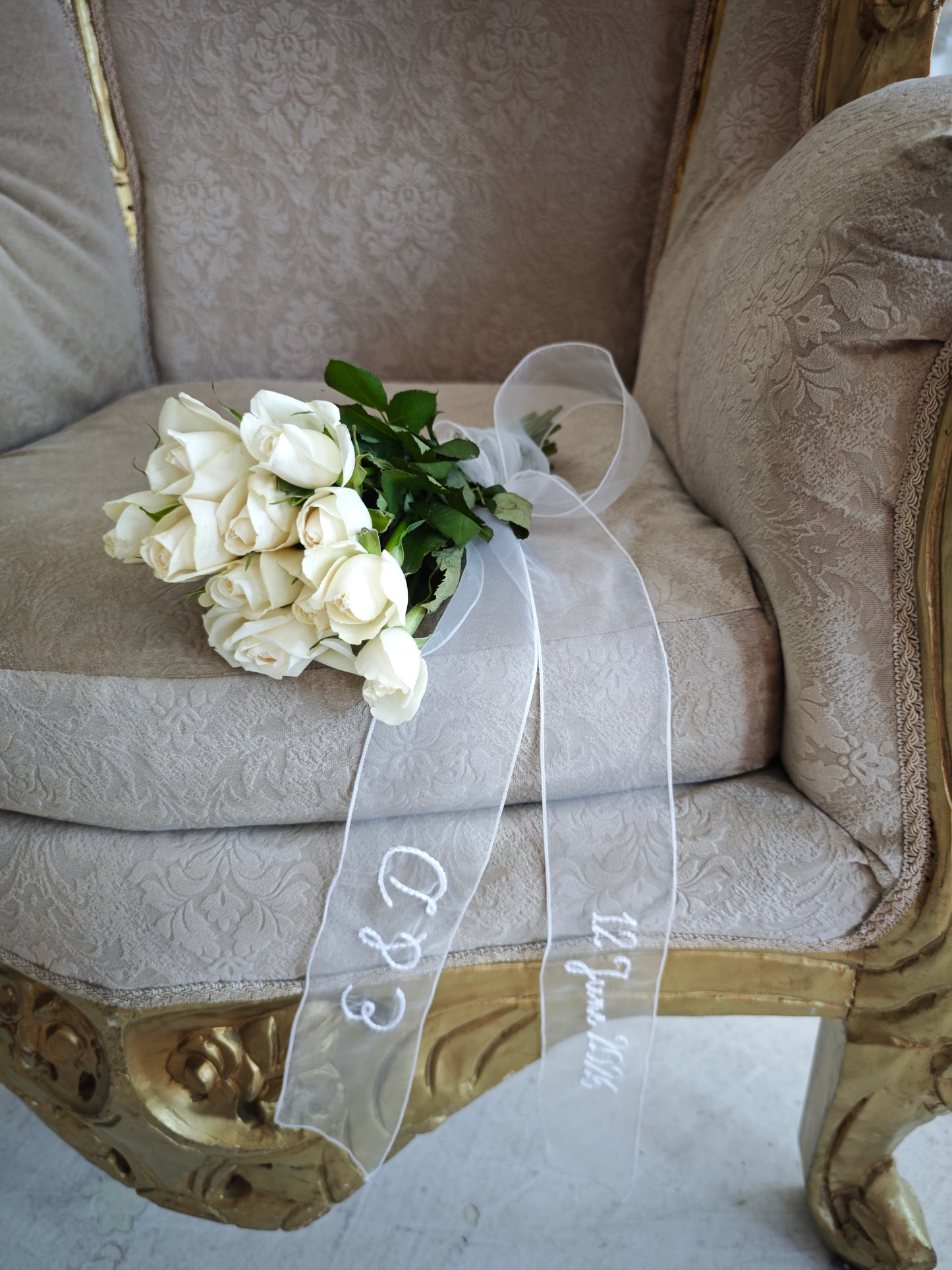 Personalized ivory organza ribbon with embroidered initials, bridal sash, flat lay