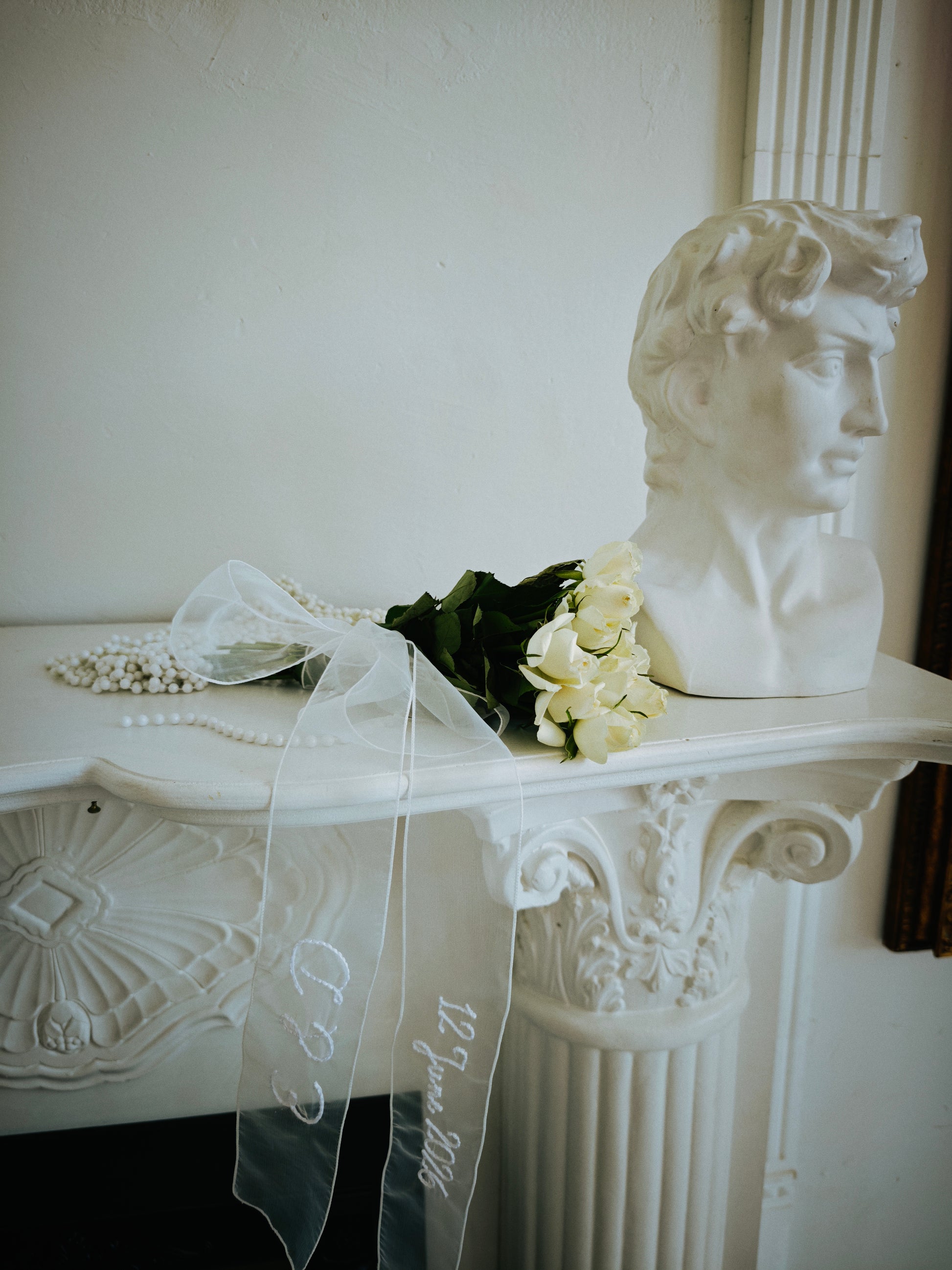 Personalized bridal ribbon in ivory organza, embroidered names and date, detail view